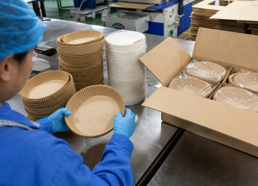 Worker inspecting air fryer paper liners