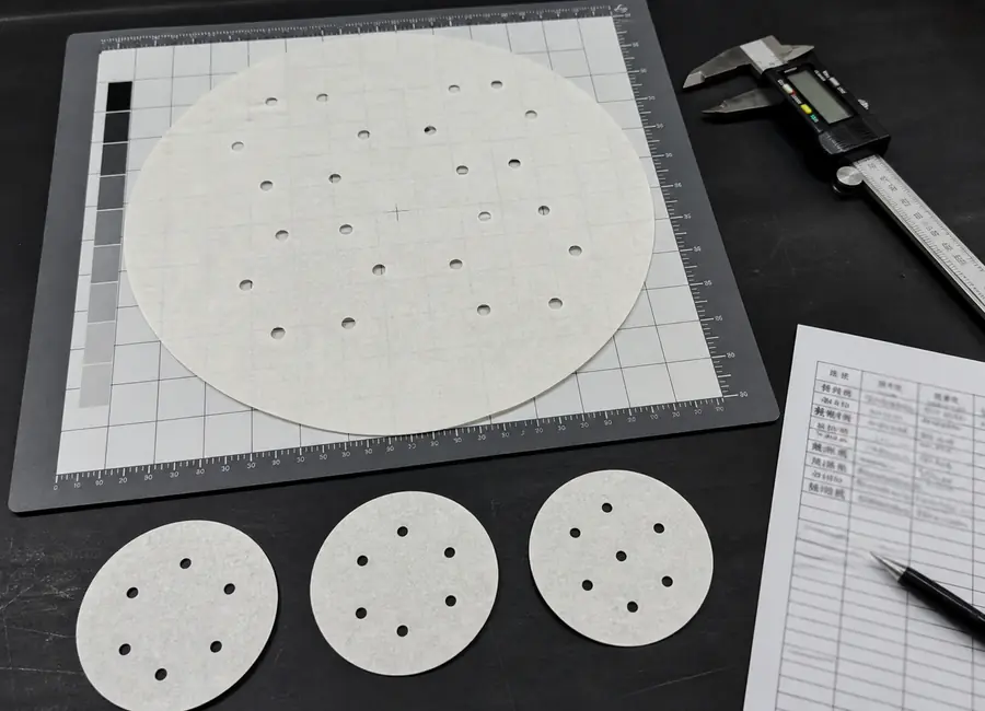 Chinese quality technician inspecting custom perforated steaming paper
