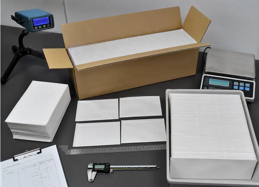 Chinese quality technician inspecting steaming paper OEM packaging