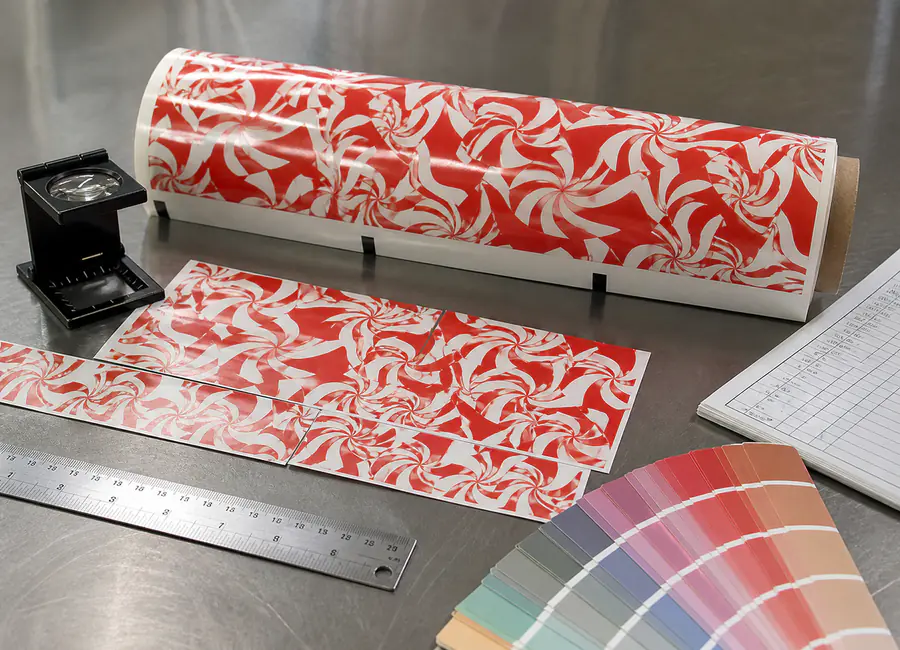 Chinese quality technician inspecting custom printed candy paper
